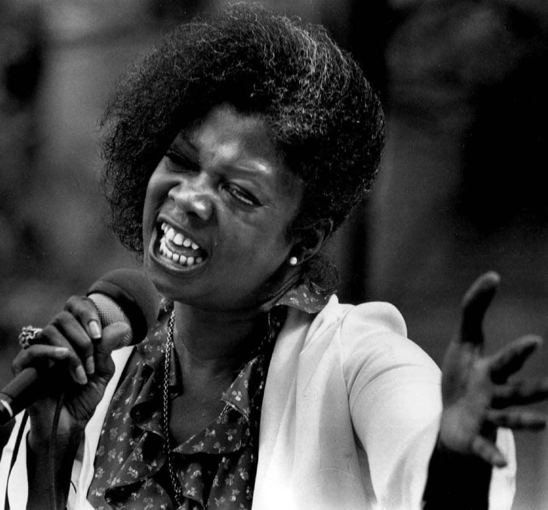 A soul singer performing passionately with a microphone
